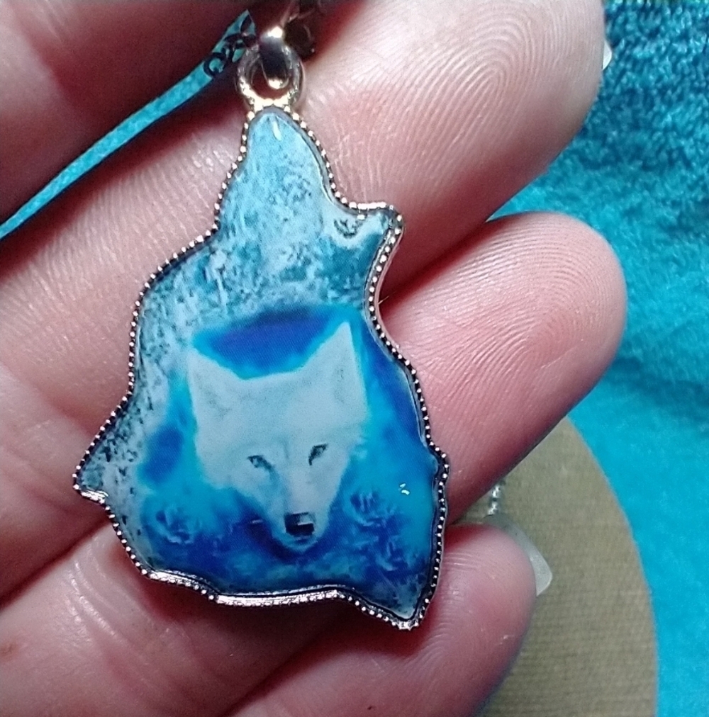 Silvertone blue white wolf necklace